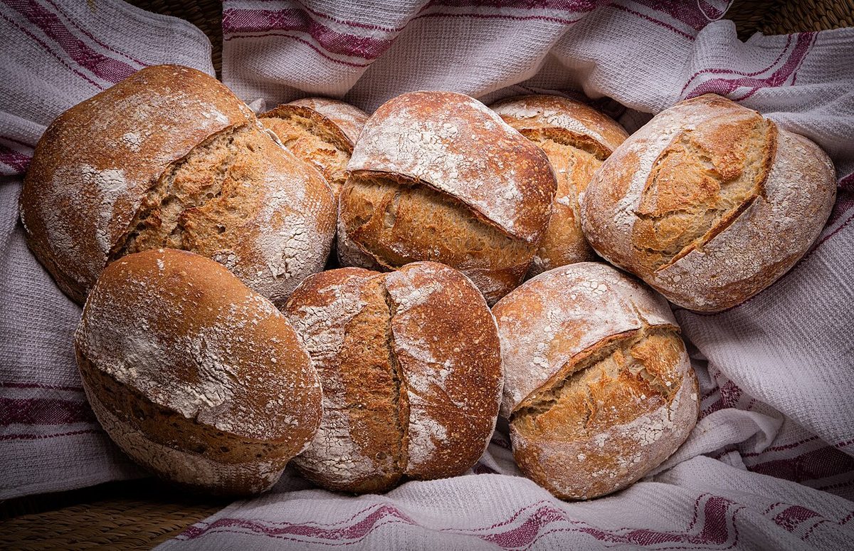 A loaf of home-made sourdough bread with a scored crust