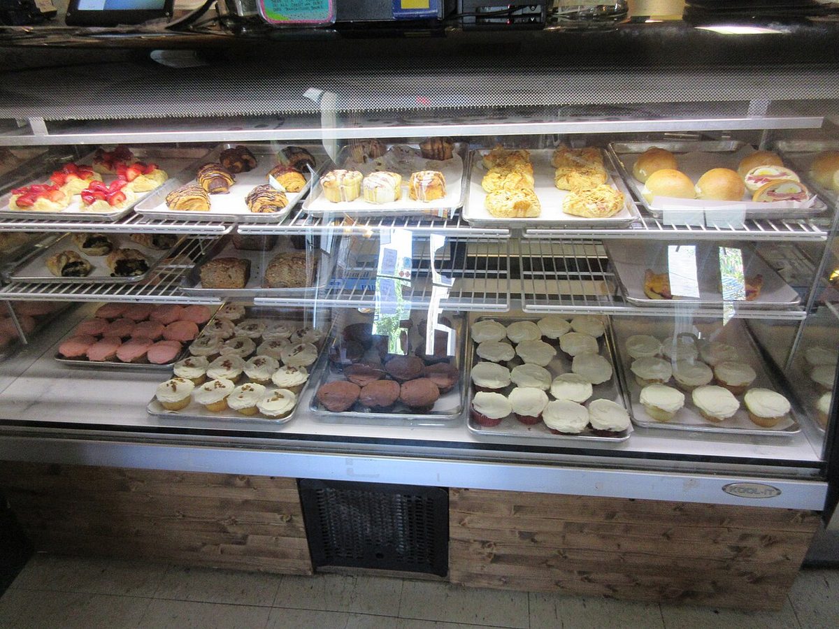 A bakery display case with cakes and pastries