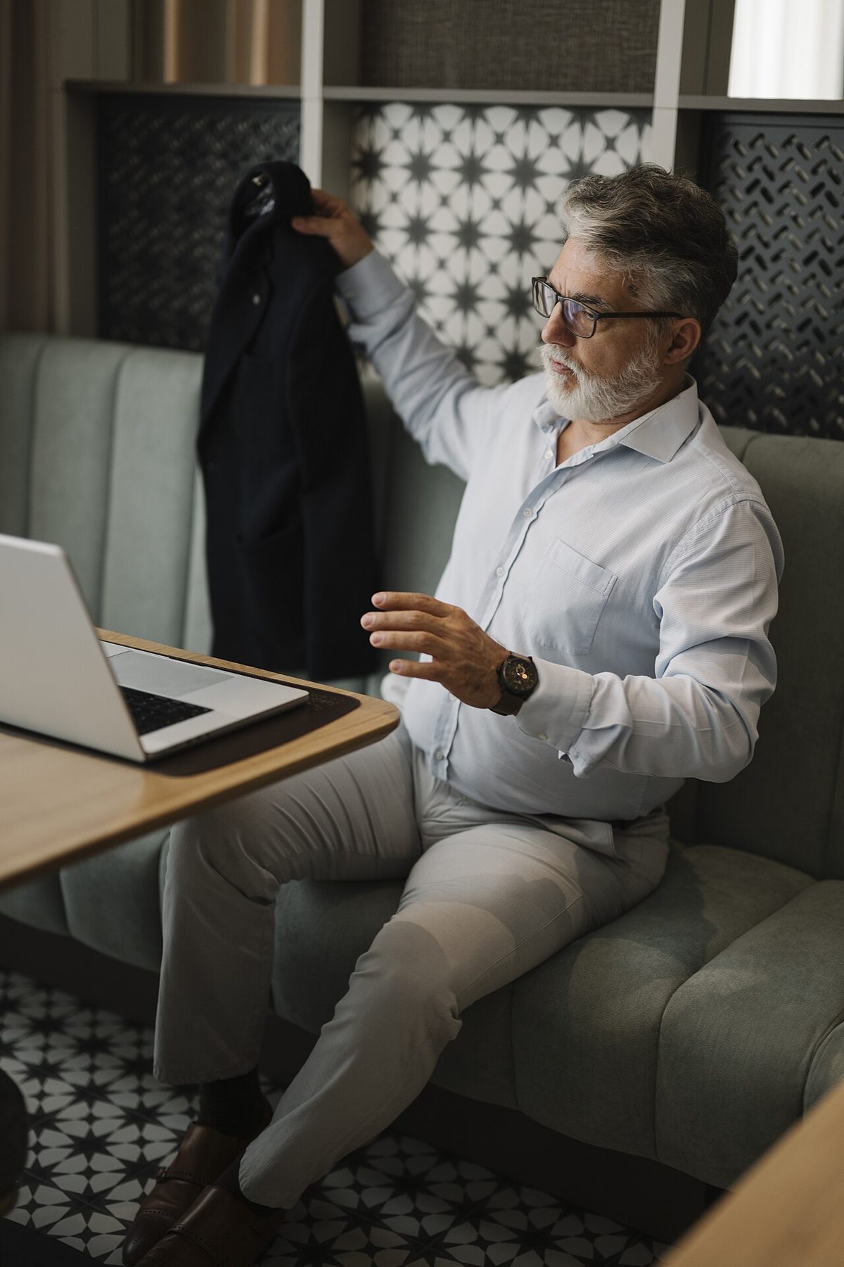 A consultant working on a laptop at a table in a modern office