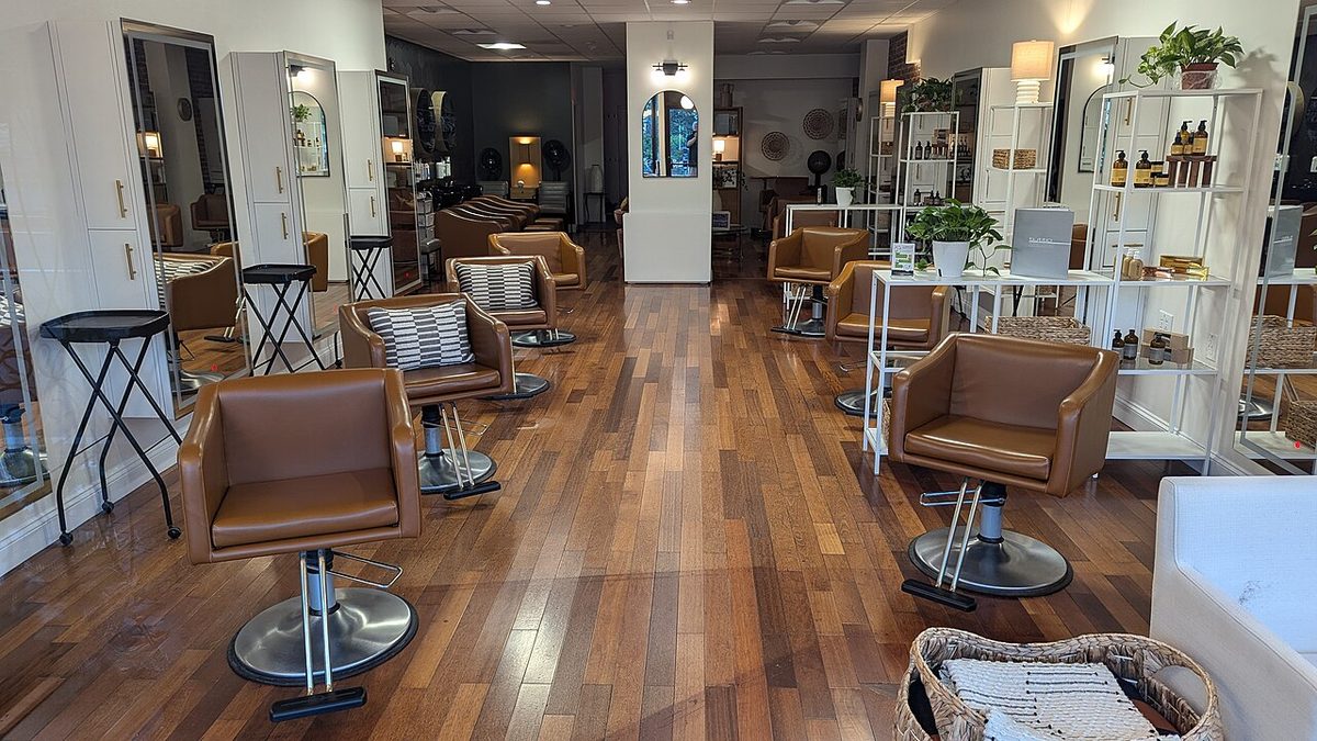 A hair salon interior with styling chairs and mirrors